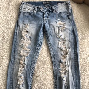 Light wash jeans with lace under rips